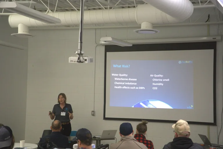 Presenter discussing water and air quality risks during the 2025 Better Pools Workshop