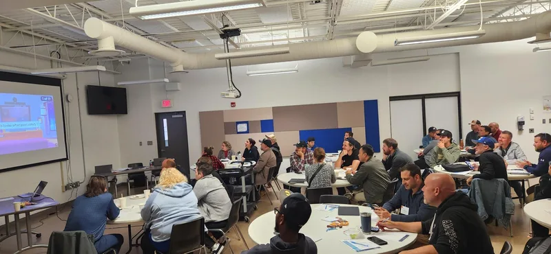 Attendees seated around tables during the 2025 Better Pools Workshop